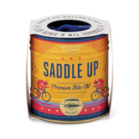 Can of 'Saddle Up' premium bike oil with colorful design and text on a white background